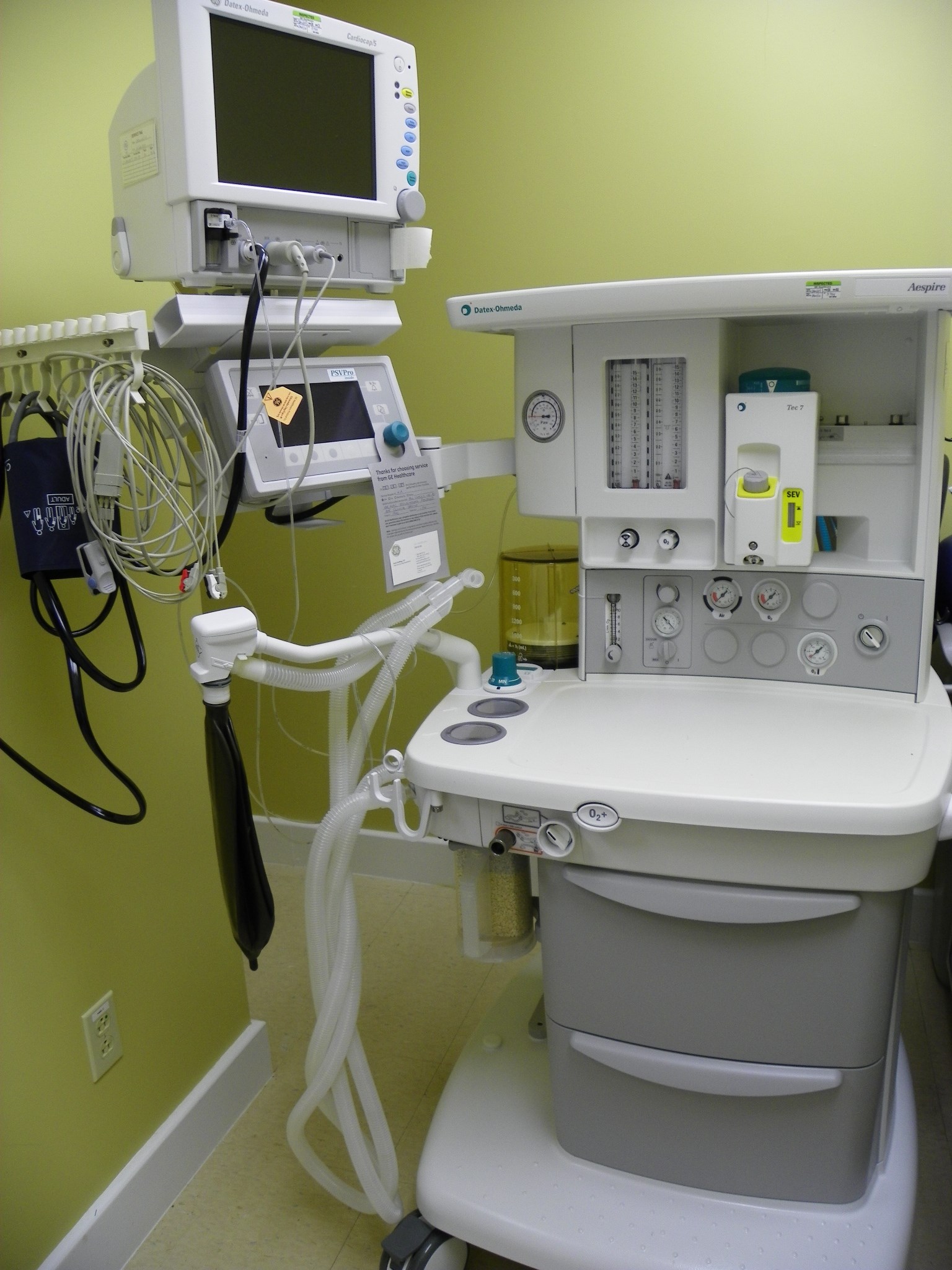 Modern medical anesthesia machine workstation with monitors and hoses