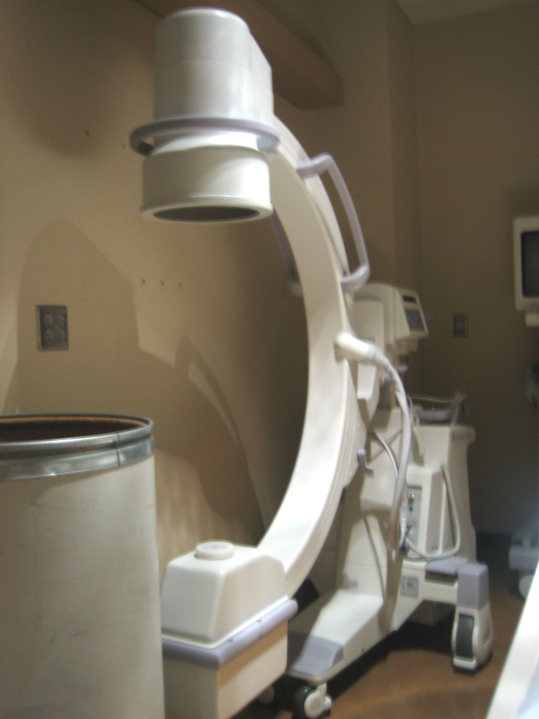 Modern digital X-ray machine with ceiling-mounted scanner arm